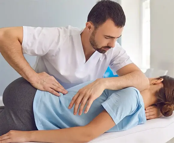 A chiropractor taking care of a patient.