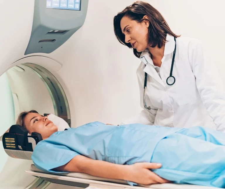A patient discussing with her doctor before entering a MRI machine.