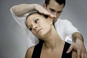 A woman getting chiropractic stretches in her neck.