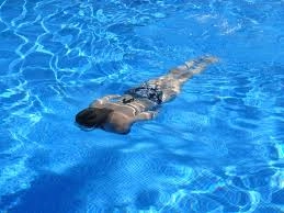 A woman swimming in a pool.