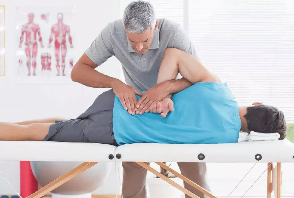 A man being treated by a chiropractor on their back.